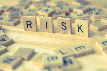 wood text RISK , risk management concept