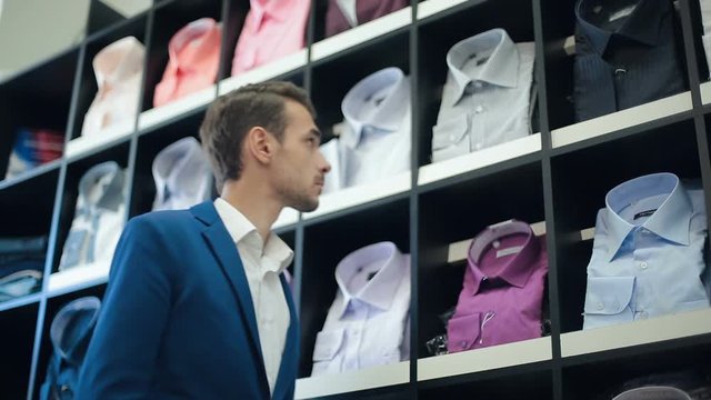 Man chooses a shirt at store