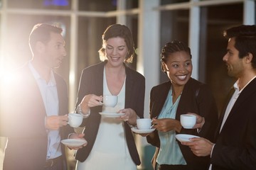 Group of businesspeople having coffee during break