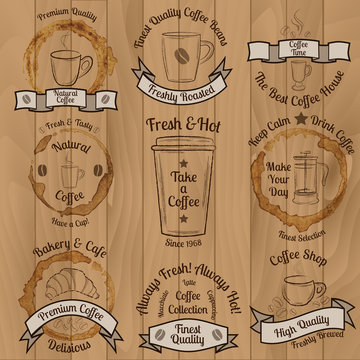 Set of brown vintage coffee badges on wooden background 
