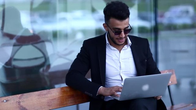 Cool Guy Arabic Man Uses Laptop in Business Center With Natural Light in Everning