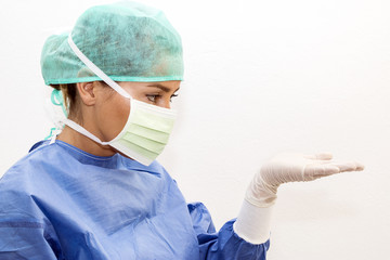 Fototapeta na wymiar Surgeon looking at something on her hand