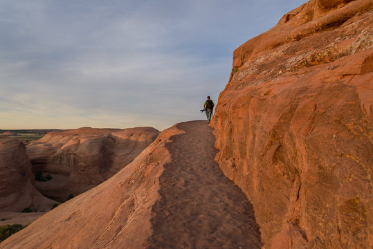 Photographer in action in the desert, Moab  / Photographer in the desert of Moab prepares for shooting, Moab. UTAH