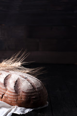wheat and bread on a wooden table
