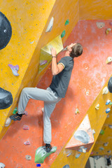 Fototapeta na wymiar young man practising climbing