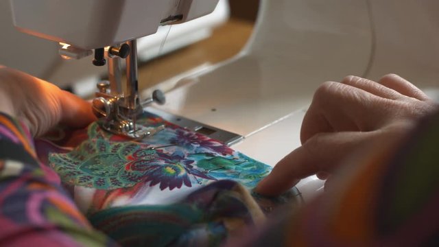 Closeup shot of woman's hand sewing on the sewing machine