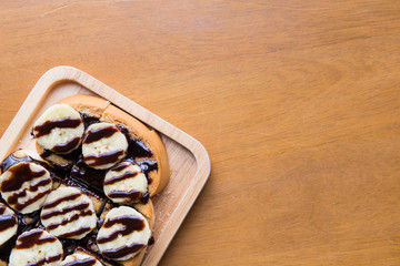 Closeup of banana with chocolate on grilled bread on left