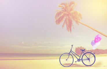 vintage bicycle on white sand beach over blue sea and clear blue sky background, spring or summer holiday vacation concept.
