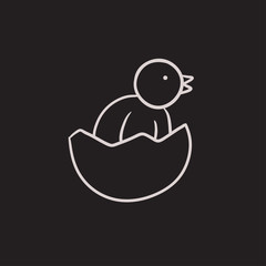 Chick peeking out of egg shell sketch icon.