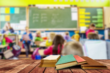 tree aged book and grunge paper on wooden platform in classroom ,back to school concept.
