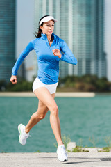 Woman running jogging near bay