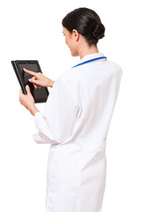 Rear over the shoulder view woman female doctor in white lab coat with digital tablet isolated on white background