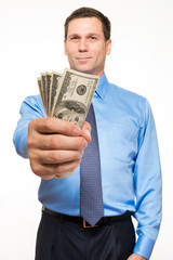 Businessman with fistful of money on white