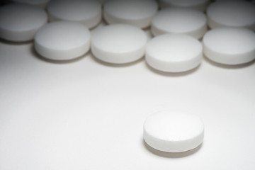White tablet pills medication on white