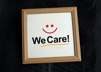 We Care - Customer Service Sign with smile in photo frame
