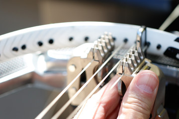 Objects: Man stringing tennis racket