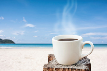 hot coffee white cup over tropical blue sea on day noon light.