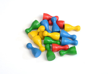 Colorful playing pawns on white background