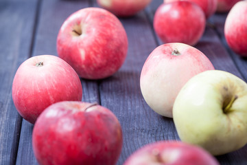 Fototapeta na wymiar red ripe apples on wooden table background