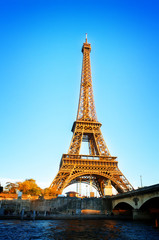 Fototapeta na wymiar Eiffel Tower over Seine river, Paris, France, retro toned