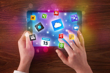 hands holding tablet