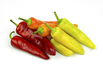 Group of orange, yellow, green and red peppers isolated on white