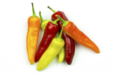 Group of orange, yellow, green and red peppers isolated on white
