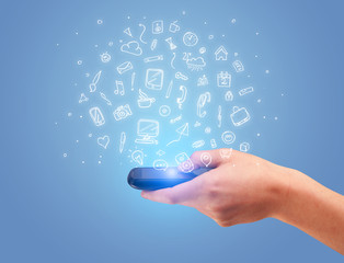 Fototapeta premium Hand with phone and drawn office icons