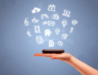 Hand holding tablet phone with drawn icons