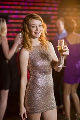 Portrait of young woman holding a glass of champagne