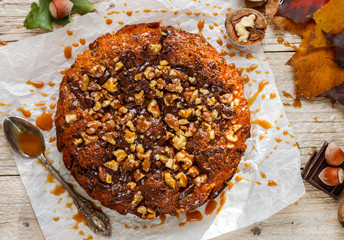 Homemade pumpkin pie with chocolate, nuts and caramel