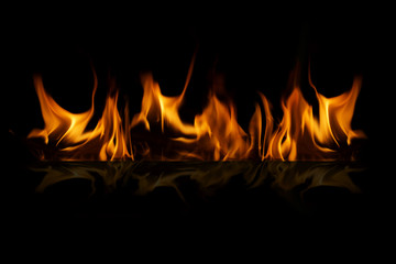 Fire flames on black background with reflection