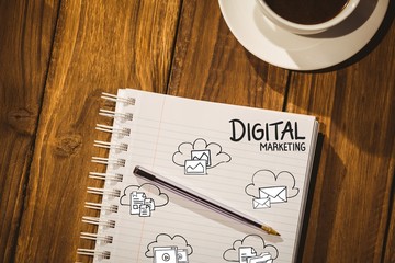 Digital marketing with graphic icons against notepad