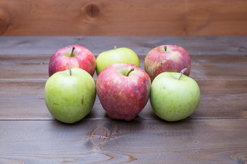 Red fresh apples on the wooden table