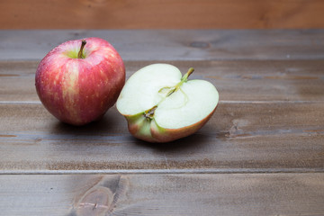Red fresh apples on the wooden table