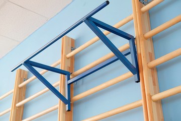 The image of a wall bar in a fitness hall