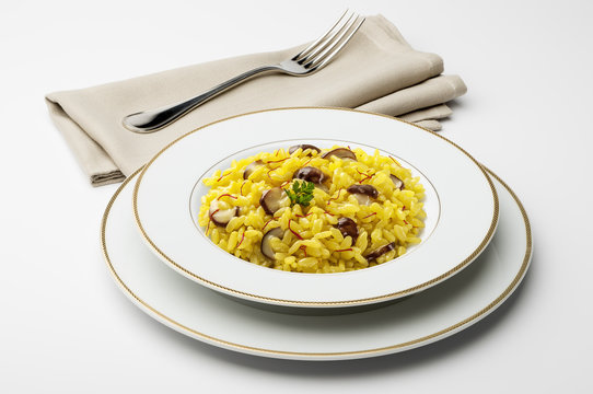 Dish with saffron risotto and mushrooms