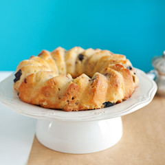 Cake Kouglof on a white plate Turquoise background