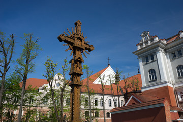 Fototapeta premium Openwork wooden cross in the monastery courtyard