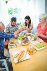 Happy couple having breakfast with their parents