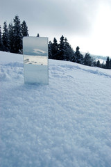 winter forest, mountains reflection in the mirror