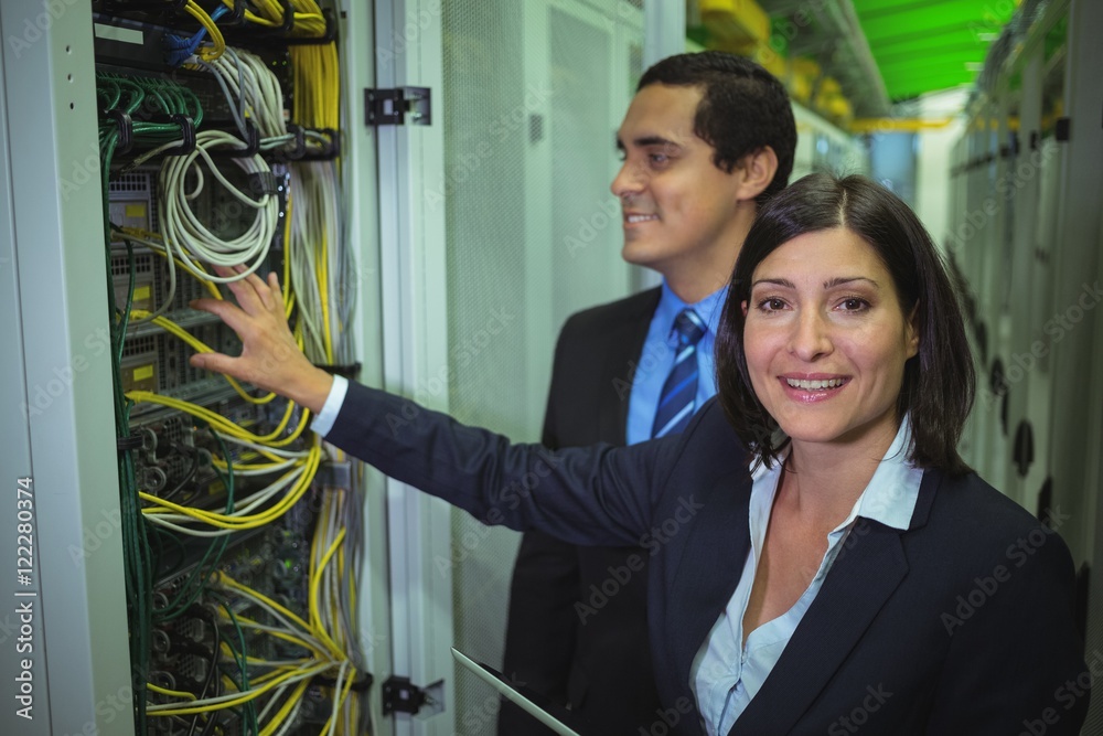 Aufkleber Technicians using digital tablet while analyzing server