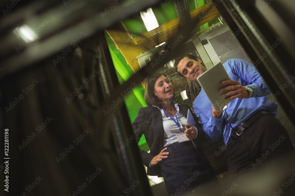 Aufkleber Technicians using digital tablet while analyzing server