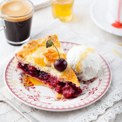 Slice of cherry pie with ice cream