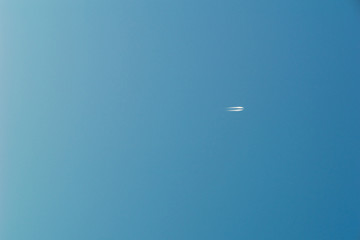 Flugzeug am blauen Himmel mit Kondensstreifen 