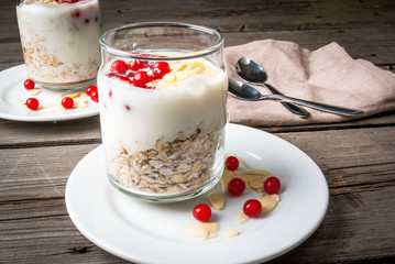 Light and healthy breakfast: oatmeal with yogurt, almonds and berries.