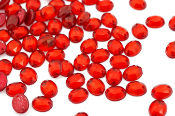 Crimson-red rhinestone on white background