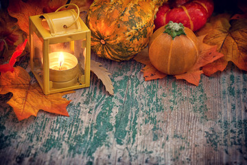 Autumn background with pumpkin and lantern on wooden table - obrazy, fototapety, plakaty