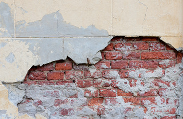 Old broken wall with visible bricks texture