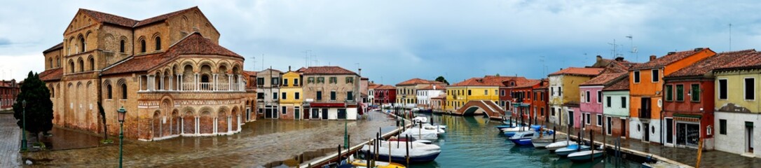 Fototapeta na wymiar The cathedral and the main canal of Murano after rain. Murano is an island in the venetian lagoon